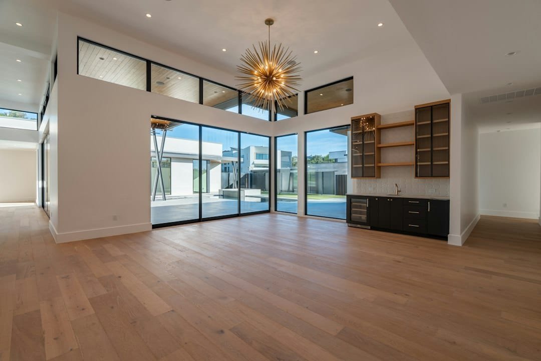 Modern open interior with engineered hardwood flooring and large windows